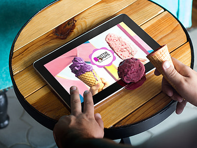 person holding tablet computer showing Nuttie Pops advertisement thumbnail