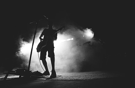 silhouette photo of man playing guitar thumbnail
