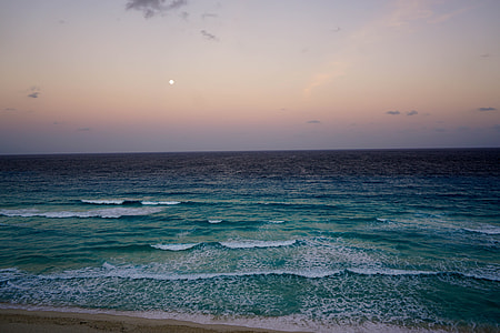 photo of green ocean during night time thumbnail