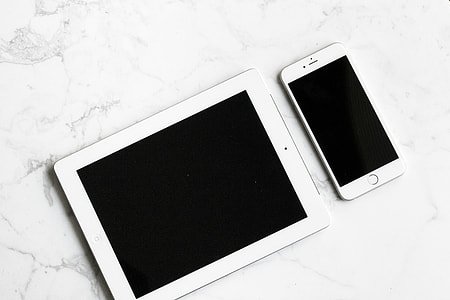 white iPad beside silver iPhone  6 thumbnail