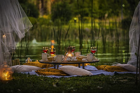 dining table near pond with throw pillows thumbnail