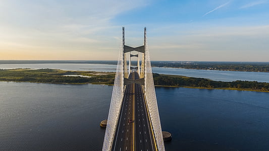 black concrete bridge on body of water thumbnail