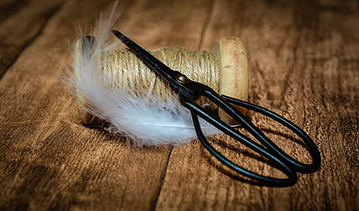 scissors on beige yarn thumbnail