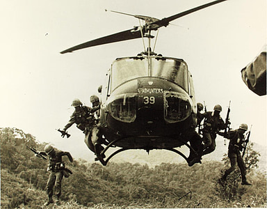 grayscale photo of soldiers jumping off helicopter thumbnail