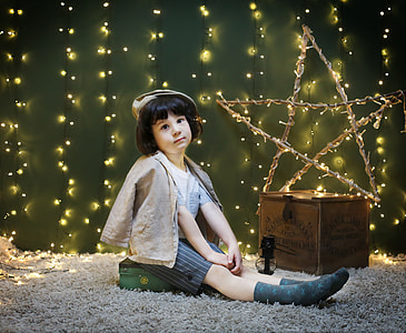 girl sitting beside brown cardboard box thumbnail