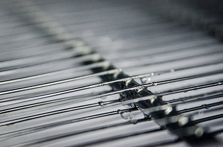 gray metal grill with water droplets selective focus photography thumbnail