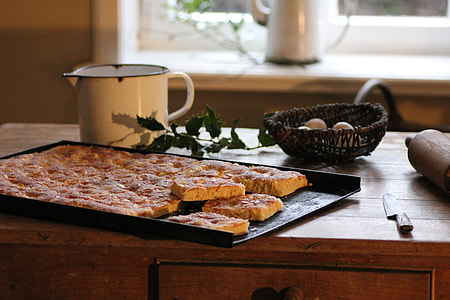 baked food on tray beside knife and rolling pin thumbnail