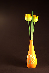 yellow tulips in brown flower vase on brown surface thumbnail
