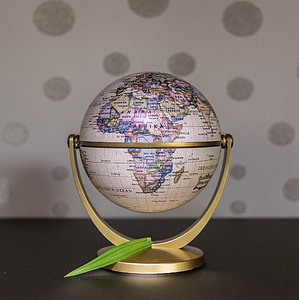 globe with gold stand on table thumbnail