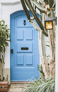 brown wooden door on white concrete wall thumbnail