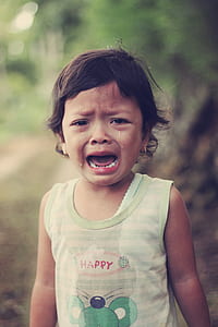 selective focus photo of crying girl wearing green shirt thumbnail