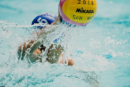 person swimming while holding 2018 Mikasa volleyball thumbnail