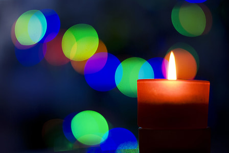 brown pillar candles,with multi-colored string lights during night time thumbnail