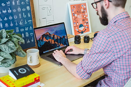 person using MacBook Pro on desk during daytime thumbnail