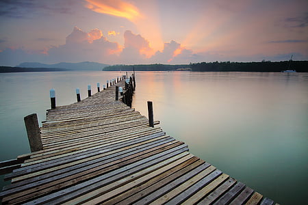 gray and brown wooden dock during golden hour thumbnail