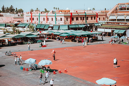 crowd of people on market surround with buildings during daytime thumbnail