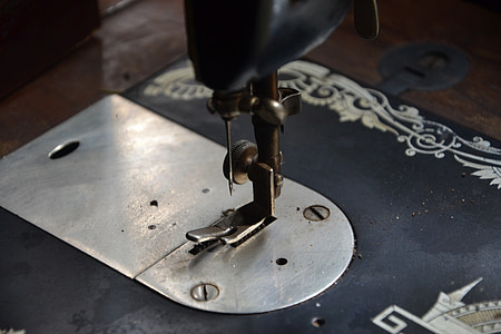 selective focus photography of sewing machine needle part thumbnail