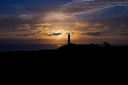 silhouette photography of lighthouse under alto cirrus clouds and sunset thumbnail