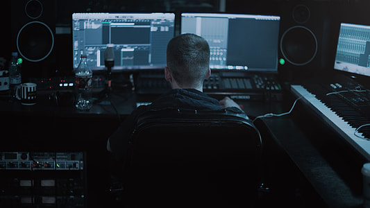 person sitting in front of computer monitors thumbnail