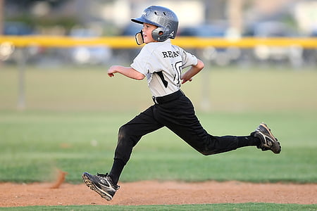 selective focus photography of boy wearing gray baseball shirt running on baseball field thumbnail