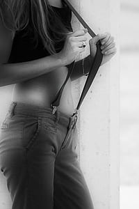 closeup photo of woman holding suspenders thumbnail