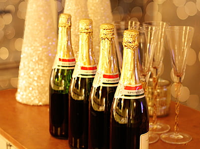 four wine bottles on brown wooden table thumbnail