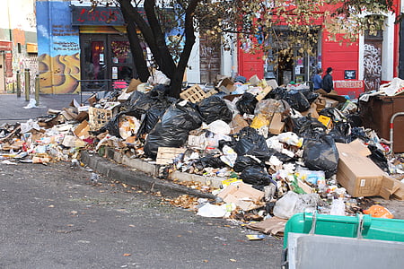 trash on road near building during daytime thumbnail