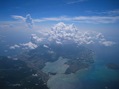 island surrounded by water under cloudy sky thumbnail