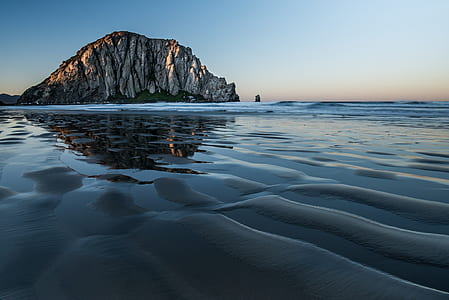 rock formation on body of water thumbnail