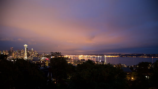 body of water across high-rise buildings during night time thumbnail