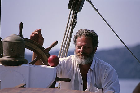 man wearing white dress shirt holding boat wheel thumbnail