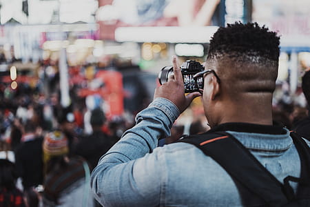 man holding DSLR camera thumbnail