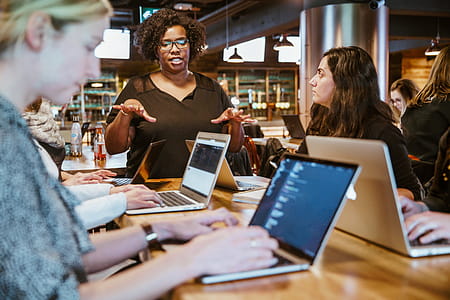 Woman Instructing On Laptop Photo thumbnail