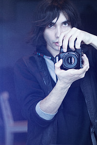 man holding DSLR camera thumbnail
