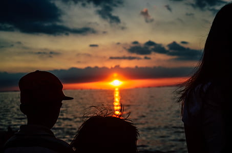 silhouette of three children looking to sunset thumbnail
