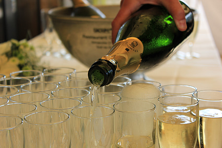 person pouring beverage into drinking glass thumbnail