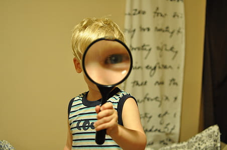 boy holding magnifying lens thumbnail