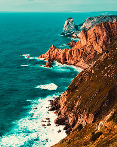 photo of mountain near seashore thumbnail