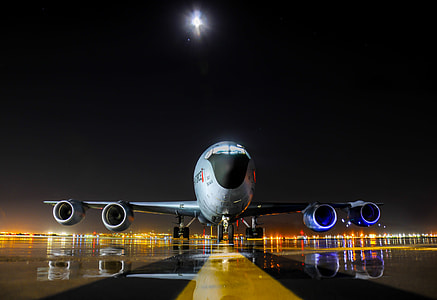 white airplane on airport during nighttime thumbnail