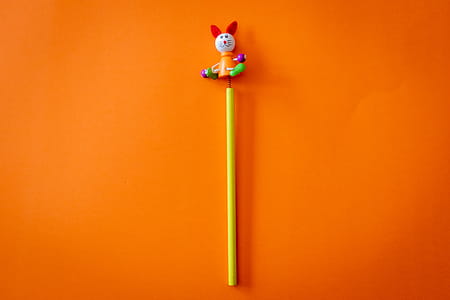 Yellow and Multicolored Animal Toy on Orange Surface thumbnail