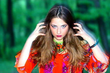 woman in red 3/4 sleeved shirt with tree background thumbnail