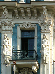 white concrete building with statues of topless women at daytime thumbnail