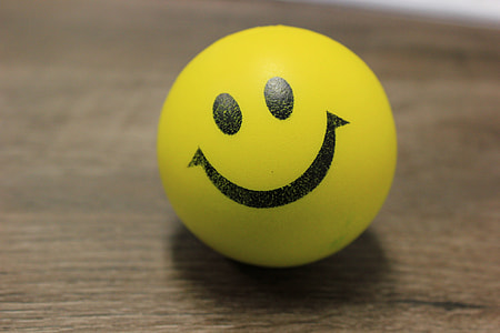 smiley ball on brown wooden surface thumbnail