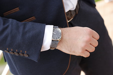 man wearing black suit and analog watch thumbnail