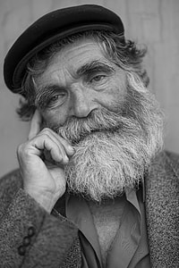 grayscale photography of man holding his right cheek thumbnail
