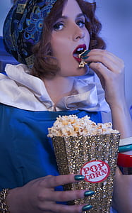 woman holding bucket of popcorn thumbnail