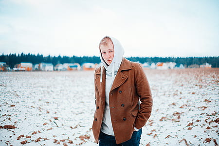 man wearing brown coat and hooded jacket thumbnail