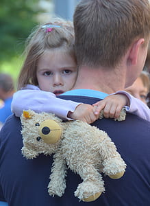 man carrying girl holding bear teddy bear thumbnail