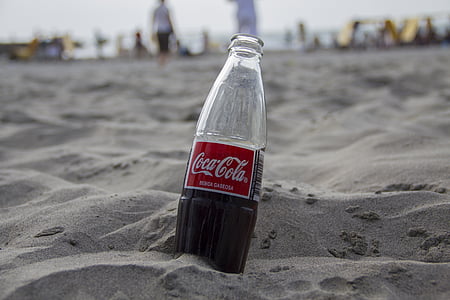 half filled Coca-Cola soda bottle thumbnail