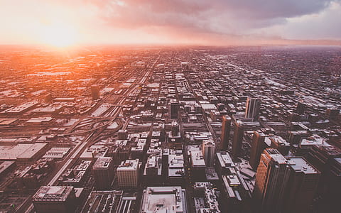 aerial photography of city buildings at sunrise thumbnail